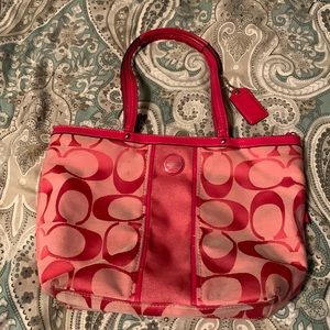 Coach bag with pink “C” pattern.